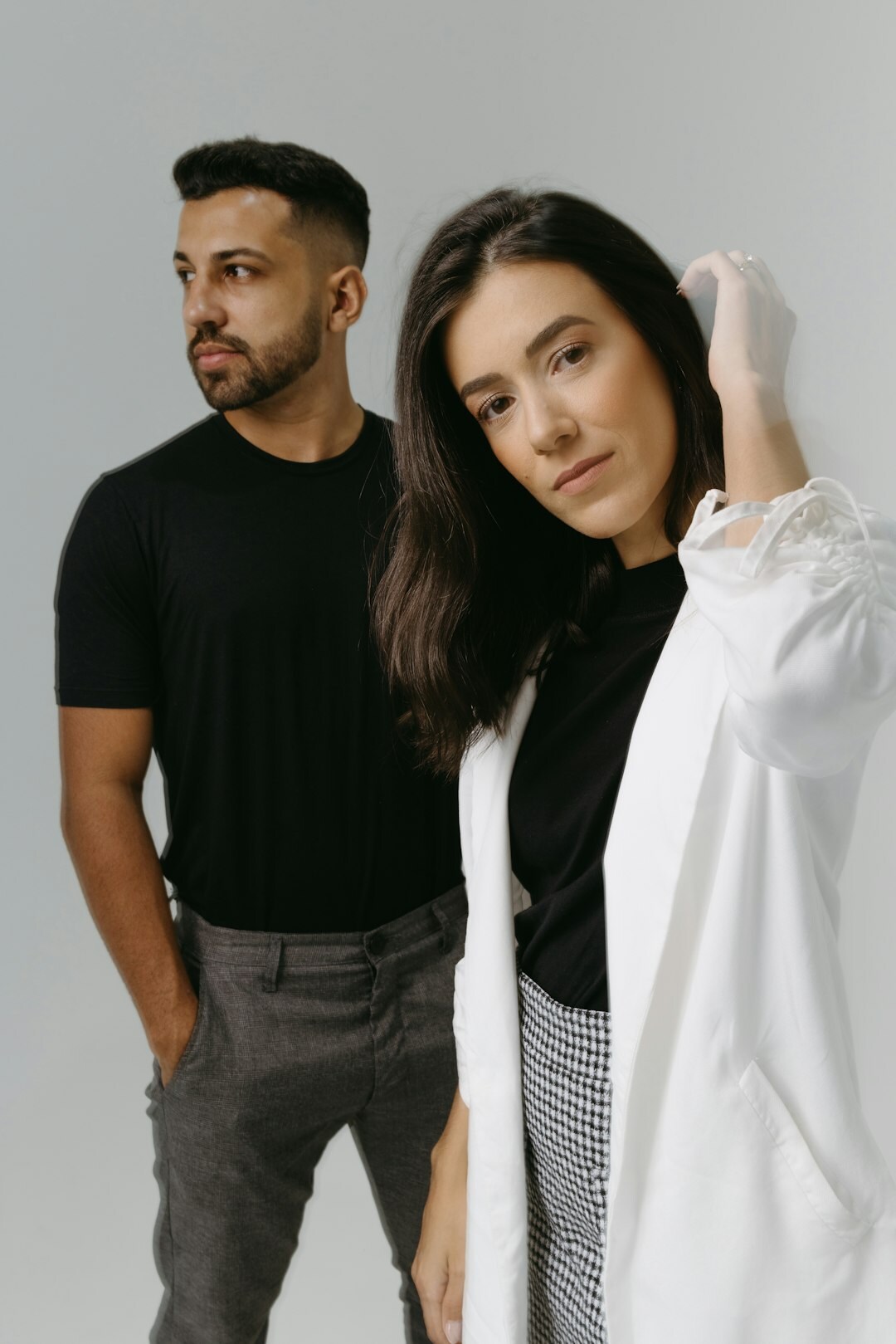 Team of podcast producers standing together in a bright studio